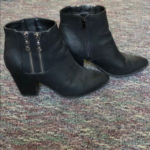 short black heeled booties with silver zippers